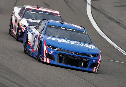 Mar 7, 2021; Las Vegas, Nevada, USA; NASCAR Cup Series driver Kyle Larson (5) leads driver Denny Hamlin (11) during the Pennzoil 400 at Las Vegas Motor Speedway.  Mandatory Credit: Gary A. Vasquez-USA TODAY Sports