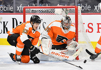 Mar 7, 2021; Philadelphia, Pennsylvania, USA; Philadelphia Flyers goaltender Carter Hart (79) and left wing Oskar Lindblom (23) makes a save against the Washington Capitals during the third period at Wells Fargo Center. Mandatory Credit: Eric Hartline-USA TODAY Sports