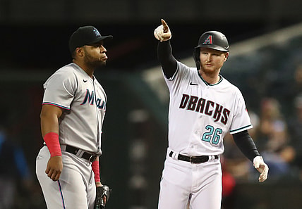 May 11, 2021; Phoenix, Arizona, USA; Miami Marlins first baseman Jesus Aguilar (left) reacts as Arizona Diamondbacks outfielder Pavin Smith celebrates after hitting an RBI single in the fifth inning at Chase Field. Mandatory Credit: Mark J. Rebilas-USA TODAY Sports
