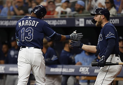 Jun 8, 2021; St. Petersburg, Florida, USA; Tampa Bay Rays right fielder Manuel Margot (13) is congratulated by designated hitter Austin Meadows (17) after he hits a home run against the Washington Nationals during the first inning at Tropicana Field. Mandatory Credit: Kim Klement-USA TODAY Sports