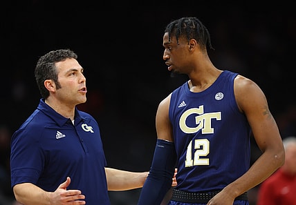Dec 18, 2021; Phoenix, Arizona, USA; Georgia Tech Yellow Jackets coach Josh Pastner talks to forward Khalid Moore (12) against the Southern California Trojans during the Colangelo Classic at Footprint Center. Mandatory Credit: Mark J. Rebilas-USA TODAY Sports