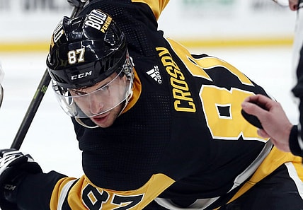 Dec 30, 2023; Pittsburgh, Pennsylvania, USA; Pittsburgh Penguins center Sidney Crosby (87) eyes the puck on a face-off against the St. Louis Blues during the first period at PPG Paints Arena. Mandatory Credit: Charles LeClaire-USA TODAY Sports