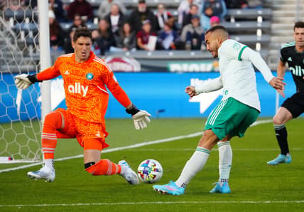 Apr 23, 2022; Commerce City, Colorado, USA; Colorado Rapids forward Andre Shinyashiki (9) kicks the ball at Charlotte FC goalkeeper Kristijan Kahlina (1) in the first half against Charlotte FC at Dick's Sporting Goods Park. Mandatory Credit: Ron Chenoy-USA TODAY Sports