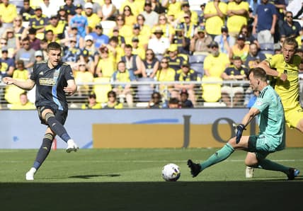 May 1, 2022; Nashville, Tennessee, USA;  Philadelphia Union forward Mikael Uhre (7) takes a shot on goal past Nashville SC goalkeeper Joe Willis (1) and scores during the second half at Geodis Park. Mandatory Credit: Steve Roberts-USA TODAY Sports