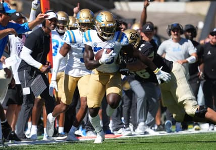Sep 24, 2022; Boulder, Colorado, USA; UCLA Bruins linebacker Carl Jones Jr. (35) returns a  interception in the third quarter against the Colorado Buffaloes at Folsom Field. Mandatory Credit: Ron Chenoy-USA TODAY Sports