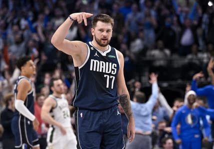Dec 9, 2022; Dallas, Texas, USA; Dallas Mavericks guard Luka Doncic (77) celebrates forward Maxi Kleber (not pictured) making a three point basket against the Milwaukee Bucks during the second half at the American Airlines Center. Mandatory Credit: Jerome Miron-USA TODAY Sports