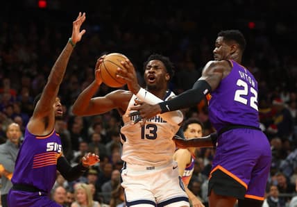 Dec 23, 2022; Phoenix, Arizona, USA; Memphis Grizzlies forward Jaren Jackson Jr. (13) drives to the basket against Phoenix Suns center Deandre Ayton (22) in the first half at Footprint Center. Mandatory Credit: Mark J. Rebilas-USA TODAY Sports