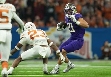 Dec 29, 2022; San Antonio, Texas, USA;  Washington Huskies running back Wayne Taulapapa (21) cuts back in front of Texas Longhorns defensive back Jahdae Barron during the first half in the 2022 Alamo Bowl at the Alamodome. Mandatory Credit: Daniel Dunn-USA TODAY Sports