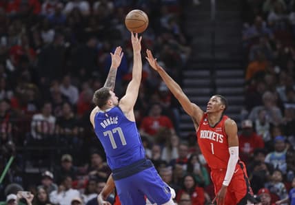 Jan 2, 2023; Houston, Texas, USA; Dallas Mavericks guard Luka Doncic (77) shoots the ball as Houston Rockets forward Jabari Smith Jr. (1) defends during the second quarter at Toyota Center. Mandatory Credit: Troy Taormina-USA TODAY Sports