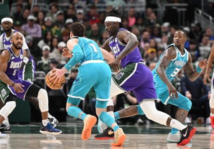 Jan 6, 2023; Milwaukee, Wisconsin, USA; Charlotte Hornets guard LaMelo Ball (1) drives against Milwaukee Bucks guard Jrue Holiday (21) in the first half at Fiserv Forum. Mandatory Credit: Michael McLoone-USA TODAY Sports