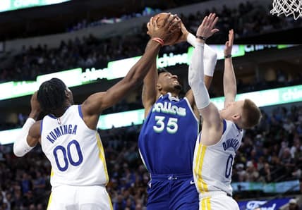 Nov 29, 2022; Dallas, Texas, USA;  Dallas Mavericks center Christian Wood (35) shoots as Golden State Warriors forward Jonathan Kuminga (00) and Golden State Warriors guard Donte DiVincenzo (0) defends during the second half at American Airlines Center. Mandatory Credit: Kevin Jairaj-USA TODAY Sports