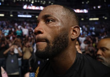 Aug 20, 2022; Salt Lake City, Utah, USA; Leon Edwards (blue gloves) leaves the arena after defeating Kamaru Usman (red gloves) during UFC 278 at Vivint Arena. Mandatory Credit: Jeffrey Swinger-USA TODAY Sports