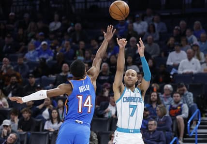 Mar 28, 2023; Oklahoma City, Oklahoma, USA; Charlotte Hornets guard Bryce McGowens (7) shoots a three point basket against Oklahoma City Thunder guard Jared Butler (14) during the second quarter at Paycom Center. Mandatory Credit: Alonzo Adams-USA TODAY Sports