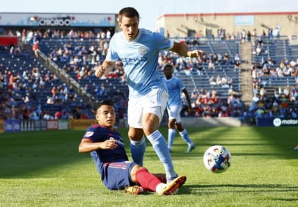 Aug 21, 2022; Chicago, Illinois, USA; Chicago Fire midfielder Jairo Torres (7) kicks the ball against New York City defender Malte Amundsen (12) during the first half at Bridgeview Stadium. Mandatory Credit: Mike Dinovo-USA TODAY Sports