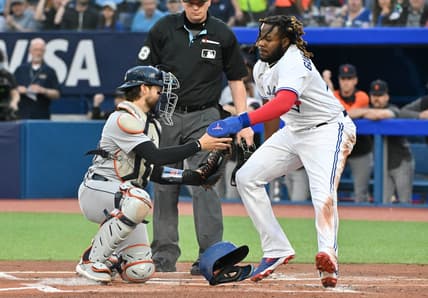 Apr 12, 2023; Toronto, Ontario, CAN;  Toronto Blue Jays first baseman Vladimir Guerrero Jr. (27) is tagged out at home by Detrot Tigers catcher Eric Haase (13) in the first inning at Rogers Centre. Mandatory Credit: Dan Hamilton-USA TODAY Sports
