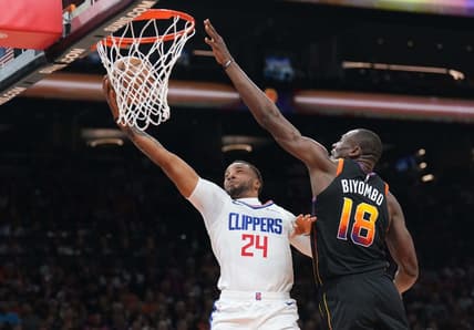 Apr 16, 2023; Phoenix, Arizona, USA; LA Clippers guard Norman Powell (24) puts up a layup against Phoenix Suns center Bismack Biyombo (18) during the first half of game one of the 2023 NBA playoffs at Footprint Center. Mandatory Credit: Joe Camporeale-USA TODAY Sports