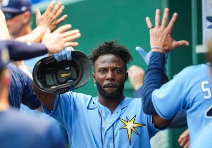 Jul 15, 2023; Kansas City, Missouri, USA; Tampa Bay Rays left fielder Randy Arozarena (56) is congratulated by teammates after scoring a run during the eighth inning against the Kansas City Royals at Kauffman Stadium. Mandatory Credit: Jay Biggerstaff-USA TODAY Sports