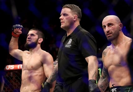 Feb 12, 2023; Perth, WA, AUSTRALIA; Islam Makhachev (red gloves) celebrates after defeating Alexander Volkanovski (blue gloves) for the lightweight championship during UFC 284 at RAC Arena. Mandatory Credit: Jasmin Frank-USA TODAY Sports