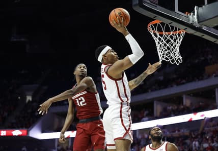 Dec 9, 2023; Tulsa, Oklahoma, USA; Oklahoma Sooners guard Rivaldo Soares (5) shoots beside Arkansas Razorbacks guard Tramon Mark (12) during the first half at BOK Center. Mandatory Credit: Alonzo Adams-USA TODAY Sports