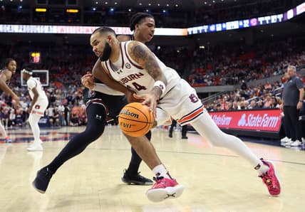 Feb 14, 2024; Auburn, Alabama, USA; South Carolina Gamecocks forward Collin Murray-Boyles (30) fouls Auburn Tigers forward Johni Broome (4) during the second half at Neville Arena. Mandatory Credit: John Reed-USA TODAY Sports