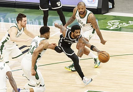 May 4, 2021; Milwaukee, Wisconsin, USA;  Brooklyn Nets' Kyrie Irving (11) reaches for the loose ball between Milwaukee Bucks forward Giannis Antetokounmpo (34) and forward P.J. Tucker (17) during the third quarter at Fiserv Forum. Mandatory Credit: Jeff Hanisch-USA TODAY Sports