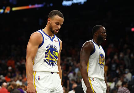 Nov 30, 2021; Phoenix, Arizona, USA; Golden State Warriors guard Stephen Curry (30) and forward Draymond Green (23) walk off the court after losing to the Phoenix Suns at Footprint Center. Mandatory Credit: Mark J. Rebilas-USA TODAY Sports