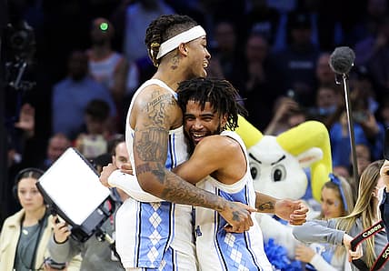 Mar 27, 2022; Philadelphia, PA, USA; North Carolina Tar Heels guard R.J. Davis (4) and forward Armando Bacot (5) celebrate after the Tar Heels defeated the St. Peters Peacocks in the finals of the East regional of the men's college basketball NCAA Tournament at Wells Fargo Center. Mandatory Credit: Bill Streicher-USA TODAY Sports