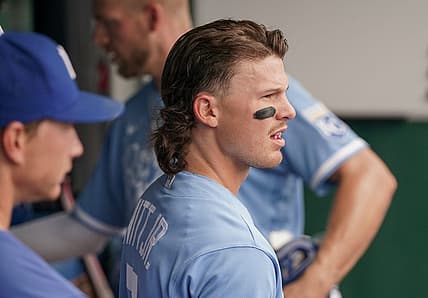 Jul 24, 2022; Kansas City, Missouri, USA; Kansas City Royals shortstop Bobby Witt Jr. (7) watches play against the Tampa Bay Rays from the dugout in the first inning at Kauffman Stadium. Mandatory Credit: Denny Medley-USA TODAY Sports