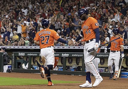 Aug 12, 2022; Houston, Texas, USA; Houston Astros designated hitter Yordan Alvarez (44) celebrates  second baseman Jose Altuve (27) run against the Oakland Athletics in the fifth inning at Minute Maid Park. Mandatory Credit: Thomas Shea-USA TODAY Sports