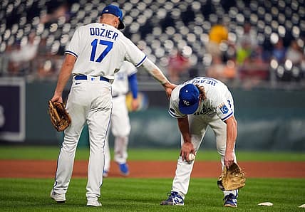 Aug 23, 2022; Kansas City, Missouri, USA; Kansas City Royals third baseman Hunter Dozier (17) talks with starting pitcher Jonathan Heasley (49) as he gets sick on the field during the fourth inning against the Arizona Diamondbacks at Kauffman Stadium. Mandatory Credit: Jay Biggerstaff-USA TODAY Sports