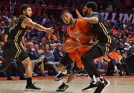 Nov 25, 2022; Champaign, Illinois, USA; Illinois Fighting Illini guard Jayden Epps (3) drives the ball between Lindenwood Lions guard Chris Childs (30) and Lindenwood Lions forward Cam Burell (5) during the first half at State Farm Center. Mandatory Credit: Ron Johnson-USA TODAY Sports