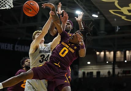 Dec 1, 2022; Boulder, Colorado, USA; Arizona State Sun Devils guard DJ Horne (0) and Colorado Buffaloes center Lawson Lovering (34) reach for a loose ball in the first half at the CU Events Center. Mandatory Credit: Ron Chenoy-USA TODAY Sports
