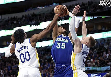 Nov 29, 2022; Dallas, Texas, USA;  Dallas Mavericks center Christian Wood (35) shoots as Golden State Warriors forward Jonathan Kuminga (00) and Golden State Warriors guard Donte DiVincenzo (0) defends during the second half at American Airlines Center. Mandatory Credit: Kevin Jairaj-USA TODAY Sports