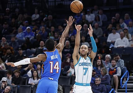Mar 28, 2023; Oklahoma City, Oklahoma, USA; Charlotte Hornets guard Bryce McGowens (7) shoots a three point basket against Oklahoma City Thunder guard Jared Butler (14) during the second quarter at Paycom Center. Mandatory Credit: Alonzo Adams-USA TODAY Sports