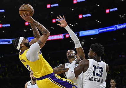 Apr 28, 2023; Los Angeles, California, USA;Los Angeles Lakers forward Anthony Davis (3) is defended by Memphis Grizzlies forward Xavier Tillman (2) and forward Jaren Jackson Jr. (13) as he goes up for a shot in the first quarter of game six of the 2023 NBA playoffs at Crypto.com Arena. Mandatory Credit: Jayne Kamin-Oncea-USA TODAY Sports