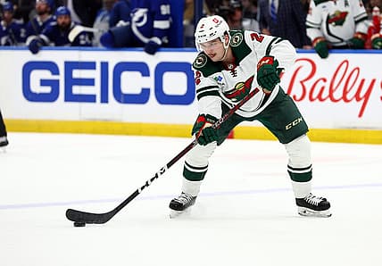 Jan 24, 2023; Tampa, Florida, USA; Minnesota Wild defenseman Calen Addison (2) passes the puck against the Tampa Bay Lightning during the second period at Amalie Arena. Mandatory Credit: Kim Klement-USA TODAY Sports
