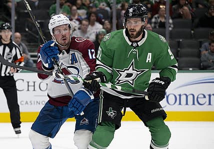 Oct 3, 2023; Dallas, Texas, USA; Colorado Avalanche center Ryan Johansen (12) and Dallas Stars center Tyler Seguin (91) battle for position in the Stars zone during the first period at the American Airlines Center. Mandatory Credit: Jerome Miron-USA TODAY Sports