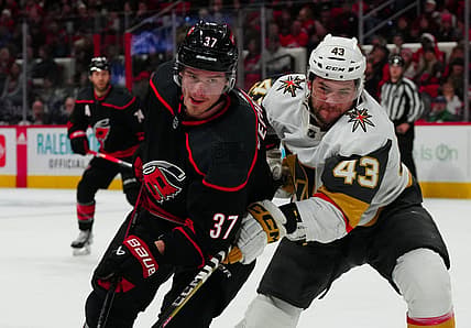 Dec 19, 2023; Raleigh, North Carolina, USA; Carolina Hurricanes right wing Andrei Svechnikov (37) and Vegas Golden Knights center Paul Cotter (43) battle for position during the first period at PNC Arena. Mandatory Credit: James Guillory-USA TODAY Sports