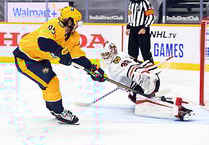 Jan 27, 2021; Nashville, Tennessee, USA; Nashville Predators center Matt Duchene (95) scores the eventual game winner on a shootout shot past Chicago Blackhawks goaltender Kevin Lankinen (32) at Bridgestone Arena. Mandatory Credit: Christopher Hanewinckel-USA TODAY Sports