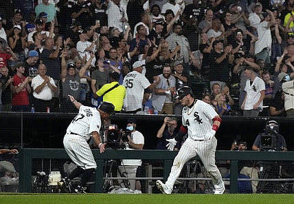 Aug 27, 2021; Chicago, Illinois, USA; Chicago White Sox catcher Yasmani Grandal (24) celebrates with third base coach Joe McEwing (47) after hitting a three-run home run against the Chicago Cubs during the third inning at Guaranteed Rate Field. Mandatory Credit: Mike Dinovo-USA TODAY Sports