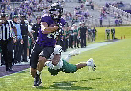 Sep 25, 2021; Evanston, Illinois, USA; Northwestern Wildcats running back Evan Hull (26) runs the ball for a touchdown as Ohio Bobcats cornerback John Gregory (13) pursues him during the first half  at Ryan Field. Mandatory Credit: David Banks-USA TODAY Sports