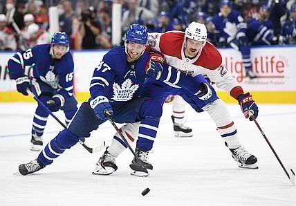 Oct 13, 2021; Toronto, Ontario, CAN;   Toronto Maple Leafs forward Pierre Engvall (47) pursues the puck ahead of Montreal Canadiens defenseman Jeff Petry (26) n the second period at Scotiabank Arena. Mandatory Credit: Dan Hamilton-USA TODAY Sports