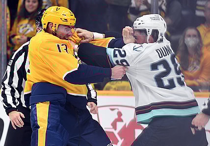 Oct 14, 2021; Nashville, Tennessee, USA; Nashville Predators center Yakov Trenin (13) and Seattle Kraken defenseman Vince Dunn (29) exchange punches during a fight during the first period at Bridgestone Arena. Mandatory Credit: Christopher Hanewinckel-USA TODAY Sports