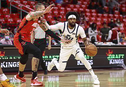 Oct 28, 2021; Houston, Texas, USA; Utah Jazz guard Mike Conley (11) dribbles the ball as Houston Rockets center Daniel Theis (27) defends during the first quarter at Toyota Center. Mandatory Credit: Troy Taormina-USA TODAY Sports