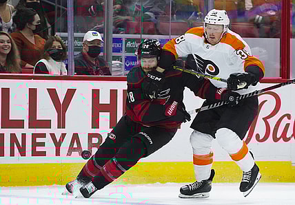 Nov 12, 2021; Raleigh, North Carolina, USA;  Philadelphia Flyers center Patrick Brown (38) and Carolina Hurricanes defenseman Ian Cole (28) chase after the puck during the first period at PNC Arena. Mandatory Credit: James Guillory-USA TODAY Sports