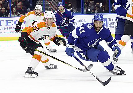 Nov 23, 2021; Tampa, Florida, USA; Tampa Bay Lightning center Pierre-Edouard Bellemare (41) and Philadelphia Flyers left wing Oskar Lindblom (23) skate after the puck during the first period at Amalie Arena. Mandatory Credit: Kim Klement-USA TODAY Sports