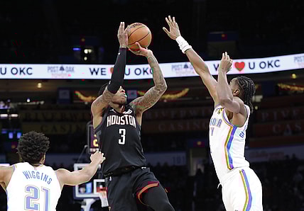 Dec 1, 2021; Oklahoma City, Oklahoma, USA; Houston Rockets guard Kevin Porter Jr. (3) shoots as Oklahoma City Thunder guard Shai Gilgeous-Alexander (2) defends during the first half at Paycom Center. Mandatory Credit: Alonzo Adams-USA TODAY Sports
