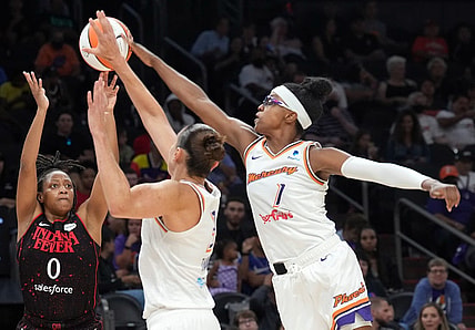 Jun 29, 2022; Phoenix, Arizona, USA; Phoenix Mercury guard Diamond DeShields (1) blocks a shot by Indiana Fever guard Kelsey Mitchell (0) during the second half at Footprint Center. Mandatory Credit: Joe Camporeale-USA TODAY Sports