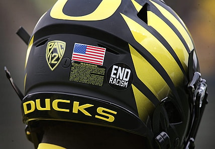 An "End racism" sticker joins the American Flag on the helmets of Oregon players Saturday Oct. 30, 2021.

Eug 103021 Uo Cofb03