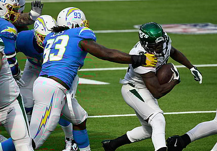 Nov 22, 2020; Inglewood, California, USA; New York Jets running back Frank Gore (21) runs past Los Angeles Chargers defensive tackle Justin Jones (93) during the first quarter at SoFi Stadium. Mandatory Credit: Robert Hanashiro-USA TODAY Sports
